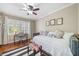 Comfortable bedroom features a daybed, desk area, neutral tones, and natural light from the window at 755 Monticello Se Way, Marietta, GA 30067
