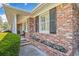 Traditional brick home with white columns, black shutters, and manicured landscaping at 755 Monticello Se Way, Marietta, GA 30067