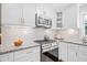Updated kitchen features stainless steel appliances, white cabinets, granite countertops and subway tile backsplash at 755 Monticello Se Way, Marietta, GA 30067