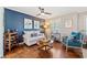 Comfortable living room with blue accent wall, hardwood floors, and lots of natural light at 755 Monticello Se Way, Marietta, GA 30067