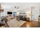 Cozy living room featuring a fireplace, hardwood floors, ceiling fan, and lots of comfortable seating at 755 Monticello Se Way, Marietta, GA 30067