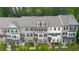 Aerial view of brick townhomes with well-kept lawns and mature trees showcasing prime location at 2022 Talmai Dr, Snellville, GA 30078