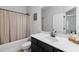 Cozy bathroom featuring a tub with shower, single sink vanity, and decorative accents at 2022 Talmai Dr, Snellville, GA 30078