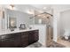 Well-lit bathroom featuring a double sink vanity and tiled walk-in shower at 2022 Talmai Dr, Snellville, GA 30078