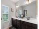 Bright bathroom showcasing double sinks, a large mirror, and ample natural light at 2022 Talmai Dr, Snellville, GA 30078