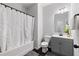Bathroom with a tub shower, gray vanity, and neutral tones, offering a clean and functional space at 2022 Talmai Dr, Snellville, GA 30078