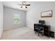 Neutral bedroom featuring a ceiling fan, window, and a desk setup at 2022 Talmai Dr, Snellville, GA 30078