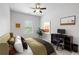 Staged bedroom includes a bed, desk area, and natural light at 2022 Talmai Dr, Snellville, GA 30078
