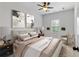 A serene bedroom features neutral tones, a ceiling fan, and hanging wall planters for a calming atmosphere at 2022 Talmai Dr, Snellville, GA 30078