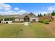 A charming clubhouse with a stone facade complements a well-manicured lawn and landscaping at 2022 Talmai Dr, Snellville, GA 30078
