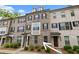 Attractive brick townhome featuring black shutters and manicured landscaping at 2022 Talmai Dr, Snellville, GA 30078