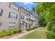 Charming townhome featuring well-manicured lawn, inviting front porch, and brick facade at 2022 Talmai Dr, Snellville, GA 30078