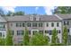 Attractive brick townhome showcases architectural design with dark shutters and well-maintained landscaping at 2022 Talmai Dr, Snellville, GA 30078