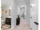 Well-lit hallway leading to a bathroom and bedroom, showcasing neutral carpet and paint at 2022 Talmai Dr, Snellville, GA 30078