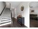 Hallway with dark floors and stairs leads to an open living area with a sleek black leather sofa at 2022 Talmai Dr, Snellville, GA 30078