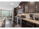Stylish kitchen with granite countertops, stainless steel appliances, and dark cabinets at 2022 Talmai Dr, Snellville, GA 30078