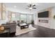 Cozy living room with fireplace, ceiling fan, neutral decor, and hardwood floors at 2022 Talmai Dr, Snellville, GA 30078