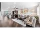Open-concept living space with hardwood floors, modern furnishings, and abundant natural light at 2022 Talmai Dr, Snellville, GA 30078