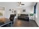 Cozy living room with black leather reclining sofa, ceiling fan, and plant for a modern, relaxing feel at 2022 Talmai Dr, Snellville, GA 30078