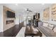 Open-concept living room with fireplace and adjacent kitchen featuring hardwood floors at 2022 Talmai Dr, Snellville, GA 30078