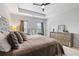 Elegantly designed main bedroom with neutral tones, tray ceiling, and ample natural light at 2022 Talmai Dr, Snellville, GA 30078