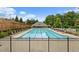 The community pool area with lounge chairs is surrounded by a fence, with an adjacent clubhouse at 2022 Talmai Dr, Snellville, GA 30078