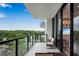 Spacious balcony features outdoor seating, glass railings and tranquil views of the lush green landscape at 2425 Peachtree Ne Rd # 902, Atlanta, GA 30305