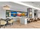 Entertainment room with multiple large screen TVs, bar seating, and a stylish contemporary design at 2425 Peachtree Ne Rd # 902, Atlanta, GA 30305