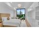 Stylish bedroom with large window offering cityscape views, complemented by elegant built-in storage at 2425 Peachtree Ne Rd # 902, Atlanta, GA 30305