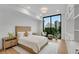 Modern bedroom with large window offering cityscape views, plus a built-in storage system at 2425 Peachtree Ne Rd # 902, Atlanta, GA 30305