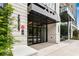 Beautiful building entrance with glass doors, stone facade, and well-maintained landscaping at 2425 Peachtree Ne Rd # 902, Atlanta, GA 30305