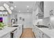 Contemporary white kitchen with stainless steel appliances, sleek countertops and modern lighting at 2425 Peachtree Ne Rd # 902, Atlanta, GA 30305