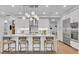 Bright white kitchen featuring a large island with seating and modern stainless steel appliances at 2425 Peachtree Ne Rd # 902, Atlanta, GA 30305