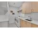 Bright laundry room with modern appliances, cabinetry and sink at 2425 Peachtree Ne Rd # 902, Atlanta, GA 30305