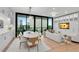Sunlit living room featuring dining area with large windows and modern furnishings at 2425 Peachtree Ne Rd # 902, Atlanta, GA 30305