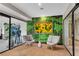 Relaxing lounge area with modern decor, comfortable seating, and a vibrant green wall showcasing a beautiful sunflower image at 2425 Peachtree Ne Rd # 902, Atlanta, GA 30305