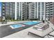 Upscale pool area with modern lounge chairs and umbrellas in a residential building at 2425 Peachtree Ne Rd # 902, Atlanta, GA 30305