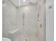 Stylish walk-in shower with marble walls, a rainfall shower head, and a built-in bench at 2425 Peachtree Ne Rd # 902, Atlanta, GA 30305