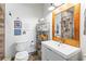 Bathroom featuring a modern vanity, a framed mirror, and a toilet with decor at 5097 Peachtree Rd # I, Atlanta, GA 30341
