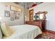Cozy bedroom with exposed ceiling and traditional furniture including wood bed and dresser at 5097 Peachtree Rd # I, Atlanta, GA 30341