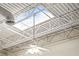 Unique industrial ceiling design with exposed beams, skylight, and modern lighting fixtures at 5097 Peachtree Rd # I, Atlanta, GA 30341