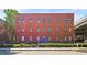 Exterior view of a three-story brick building with blue doors and a ramp for accessibility at 5097 Peachtree Rd # I, Atlanta, GA 30341