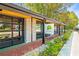 Modern building with stone accents, black framed glass doors, and a sign for Moondog Pub & Grub at 5097 Peachtree Rd # I, Atlanta, GA 30341