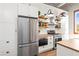 Charming kitchen features stainless steel appliances and open shelving at 5097 Peachtree Rd # I, Atlanta, GA 30341