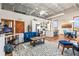 Cozy living room features a comfortable blue sofa, area rug, and adjacent kitchen and dining area at 5097 Peachtree Rd # I, Atlanta, GA 30341