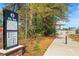 Outdoor walking path on the Rail Trail with a sign showing directions to Fish Bolt Park at 5097 Peachtree Rd # I, Atlanta, GA 30341