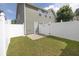 Fenced backyard features a small patio, lawn and rear view of the home at 577 Cypher Drive, Suwanee, GA 30024
