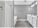 Bright bathroom featuring a combination shower and tub and a large sink with cabinets at 577 Cypher Drive, Suwanee, GA 30024