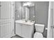 This bathroom features a modern sink, mirror, and toilet for a clean, functional space at 577 Cypher Drive, Suwanee, GA 30024