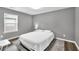 This bedroom offers a cozy space with a comfortable bed and a view through the bright window at 577 Cypher Drive, Suwanee, GA 30024